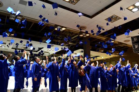 Grads throwing caps